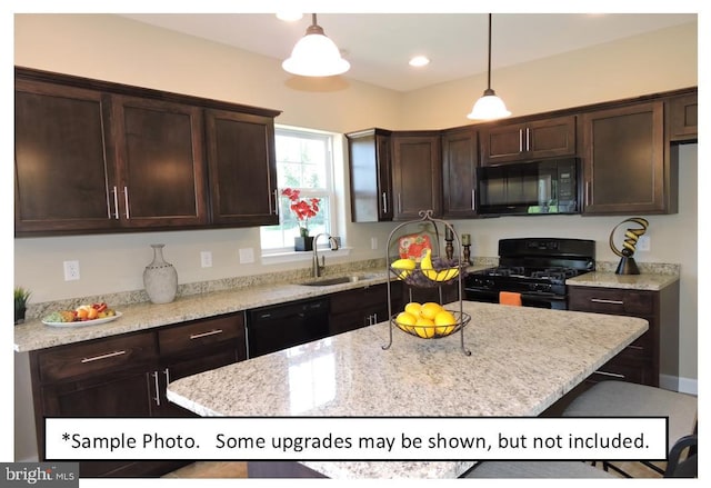 kitchen with dark brown cabinetry, black appliances, a center island, decorative light fixtures, and sink