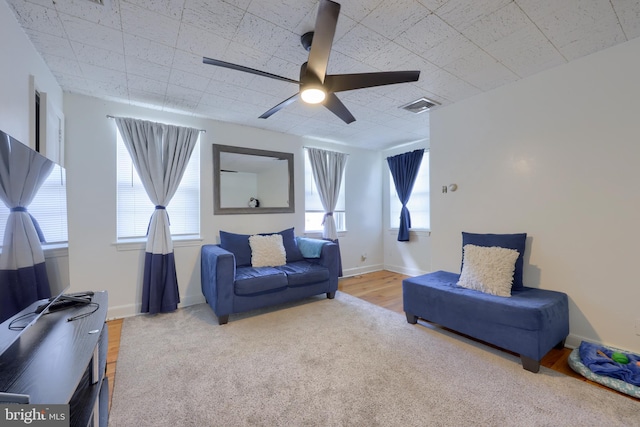 living room with ceiling fan and light hardwood / wood-style floors