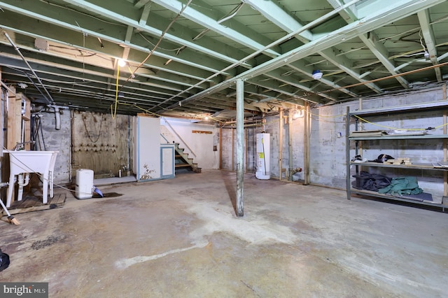 basement featuring sink and water heater