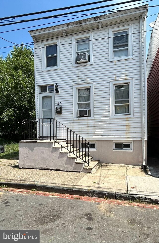 view of front of house featuring cooling unit