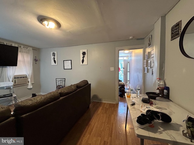 living room featuring wood-type flooring and cooling unit