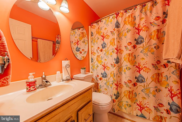 bathroom featuring curtained shower, toilet, and vanity