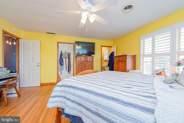 bedroom with ceiling fan, a closet, and light wood-type flooring