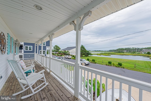 deck featuring a water view and a porch