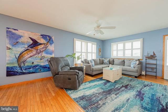 living room with ceiling fan and hardwood / wood-style flooring