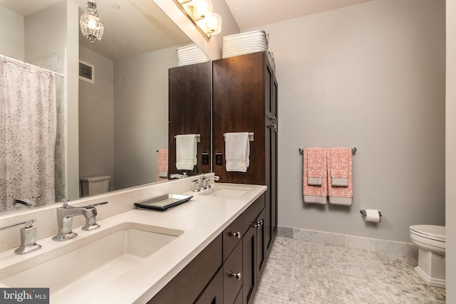 bathroom featuring toilet and vanity