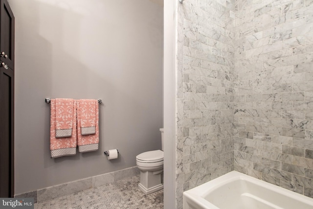 bathroom featuring toilet and a bath