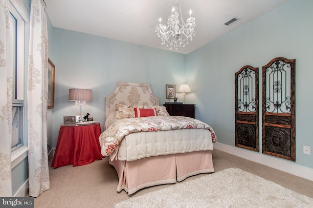 carpeted bedroom featuring a notable chandelier