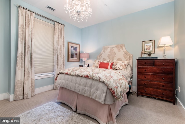 carpeted bedroom with an inviting chandelier