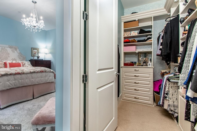 spacious closet featuring light carpet and a notable chandelier