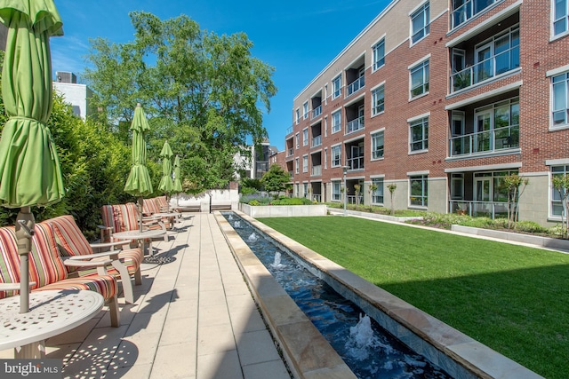 view of pool with a yard