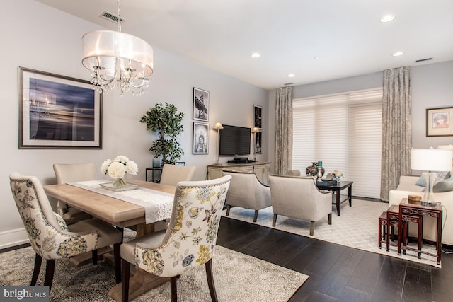 dining room featuring an inviting chandelier and hardwood / wood-style floors