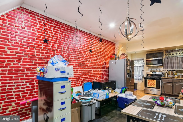 kitchen featuring stainless steel appliances and brick wall