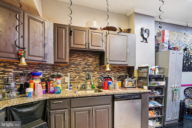 kitchen featuring sink, dishwasher, light stone counters, and decorative backsplash