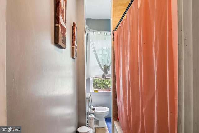 bathroom with toilet and tile patterned floors