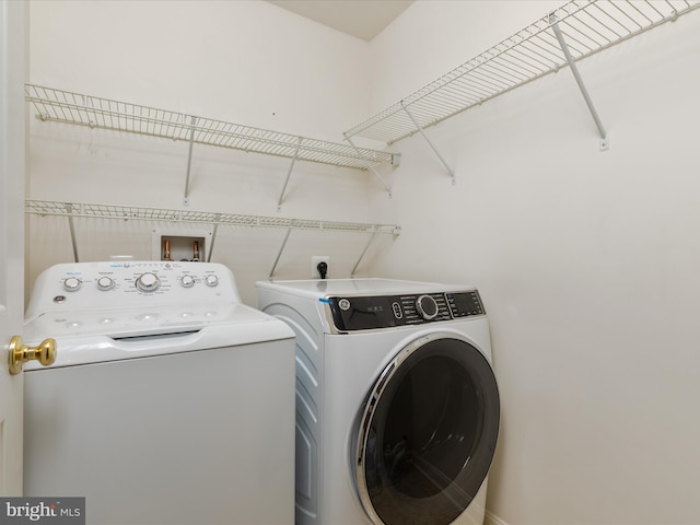 clothes washing area featuring washing machine and clothes dryer