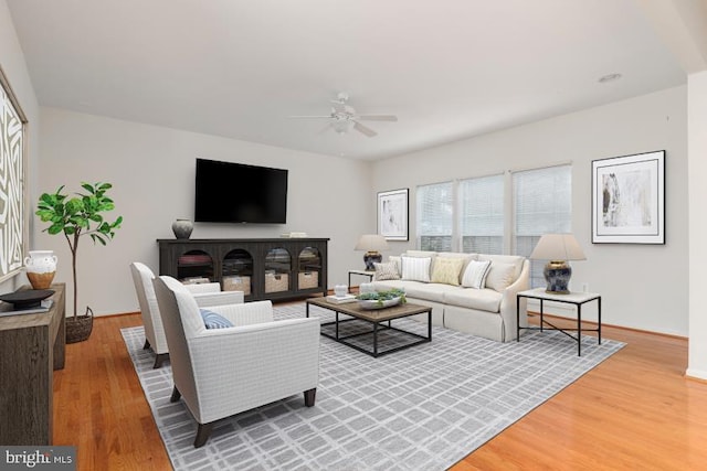 living room featuring hardwood / wood-style flooring and ceiling fan