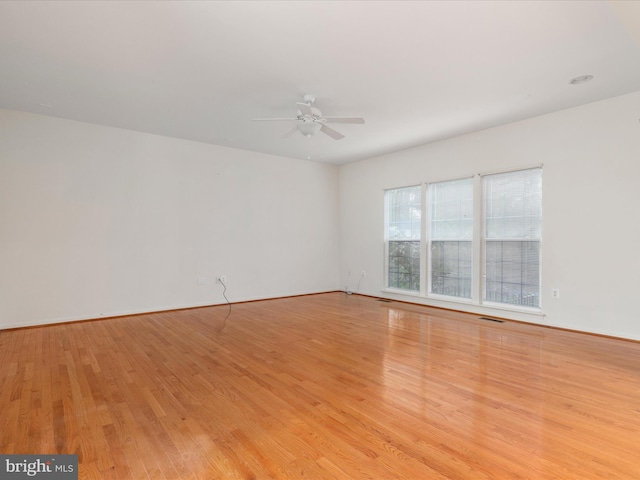 empty room with light hardwood / wood-style floors and ceiling fan