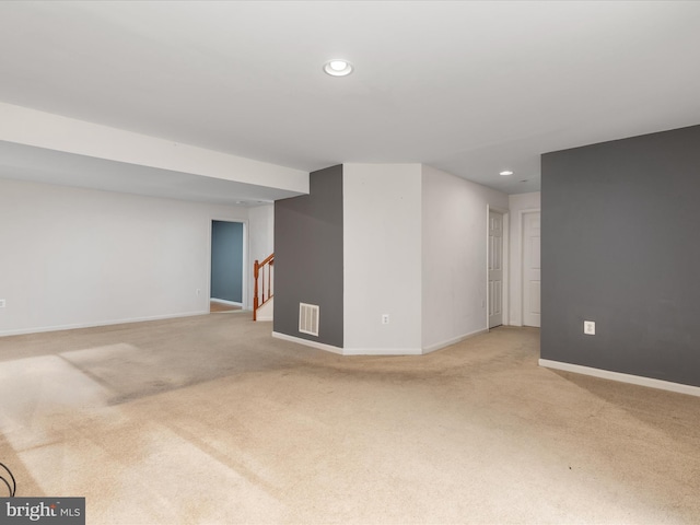 basement featuring light carpet