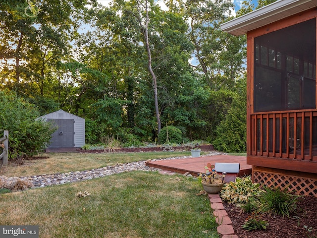 view of yard featuring a wooden deck and a shed