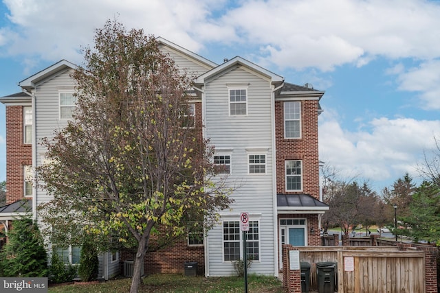 rear view of property featuring cooling unit