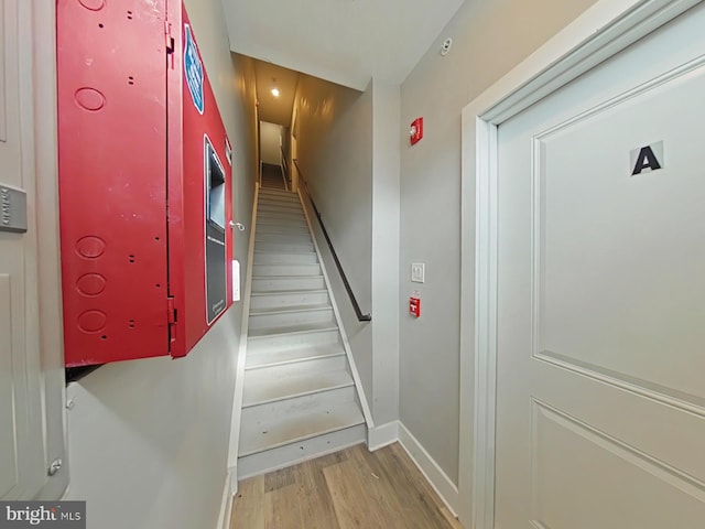 stairway featuring light wood-type flooring