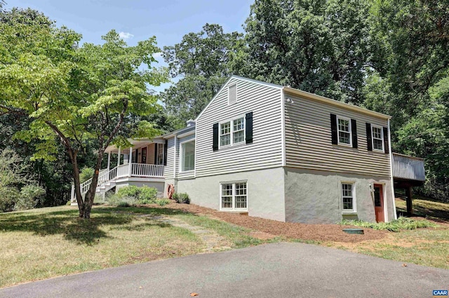 view of property exterior featuring a yard and a porch