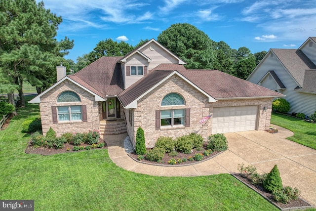 front of property with a garage and a front lawn