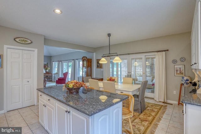 kitchen featuring light tile patterned floors, white cabinets, and a kitchen island