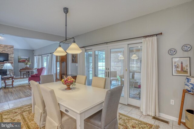 dining area with light tile patterned flooring and french doors