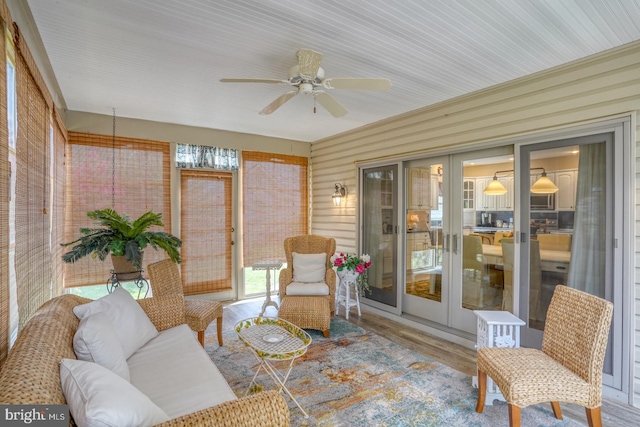 sunroom with ceiling fan and french doors