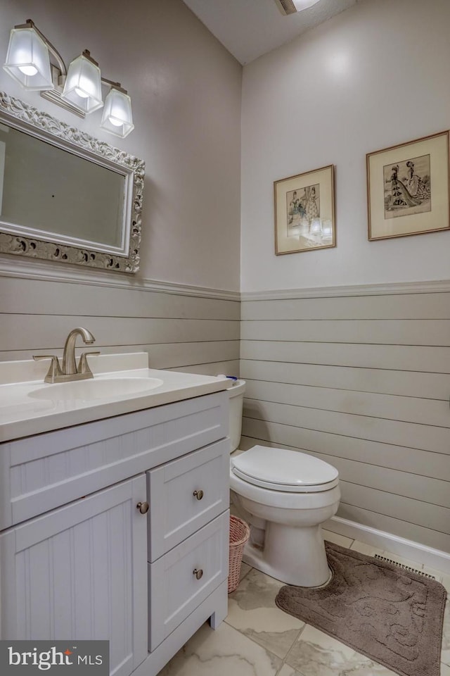 bathroom featuring tile patterned floors, toilet, and vanity