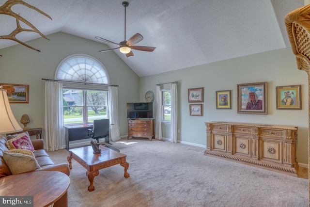 carpeted living room with ceiling fan, a textured ceiling, high vaulted ceiling, and plenty of natural light