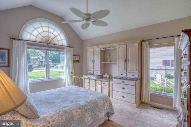 carpeted bedroom featuring lofted ceiling and ceiling fan