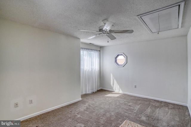 empty room featuring ceiling fan, carpet floors, and a textured ceiling