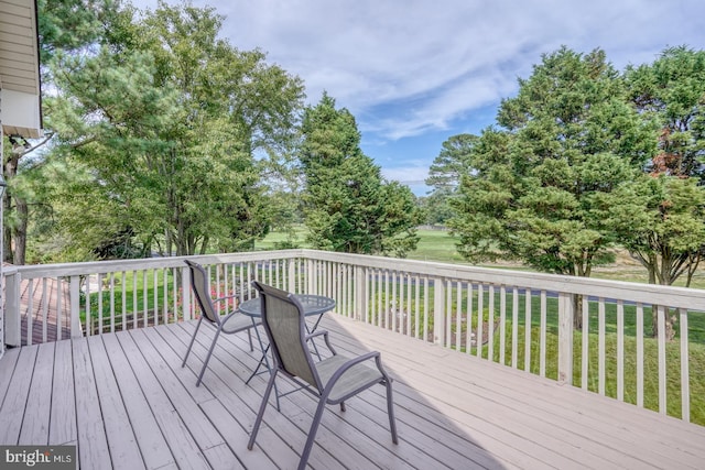 wooden terrace featuring a yard