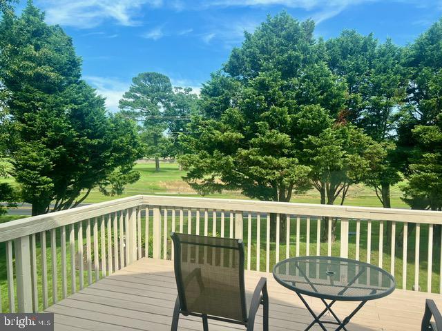 wooden deck featuring a yard