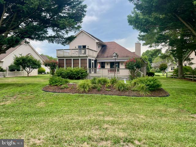 rear view of house with a lawn