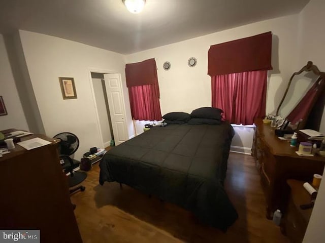 bedroom with dark hardwood / wood-style flooring