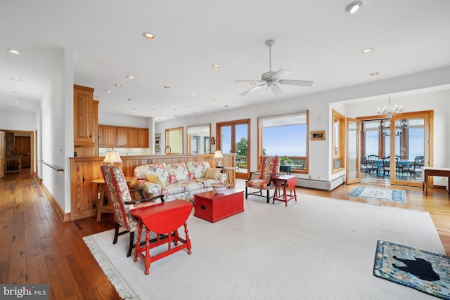 dining space with a fireplace, light hardwood / wood-style floors, and a chandelier