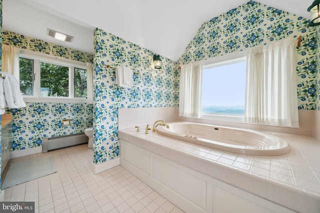 washroom with sink, a baseboard heating unit, separate washer and dryer, cabinets, and light tile patterned floors