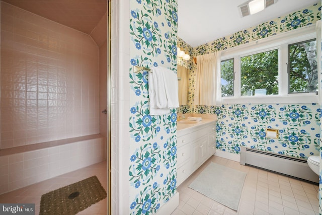 bathroom featuring a baseboard radiator, vanity, tile patterned flooring, and toilet