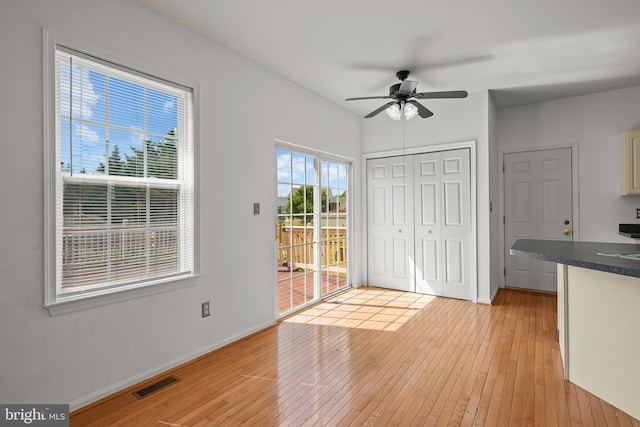 interior space with light wood-type flooring and ceiling fan