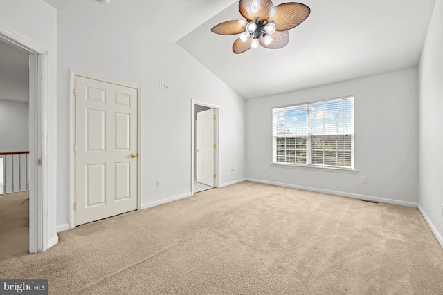 unfurnished bedroom featuring ceiling fan, light colored carpet, and lofted ceiling