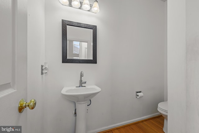 bathroom featuring toilet and hardwood / wood-style flooring