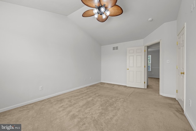 interior space featuring vaulted ceiling, ceiling fan, and light colored carpet