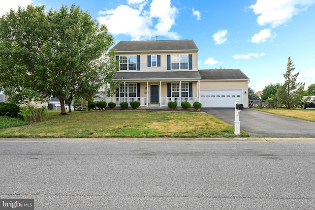 view of front of house featuring a front lawn, a porch, and a garage