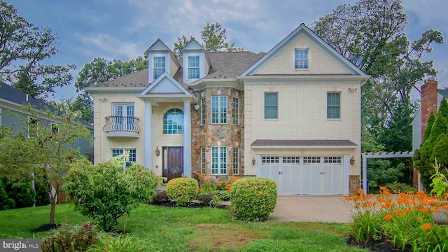 view of front of house featuring a balcony, a front yard, and a garage