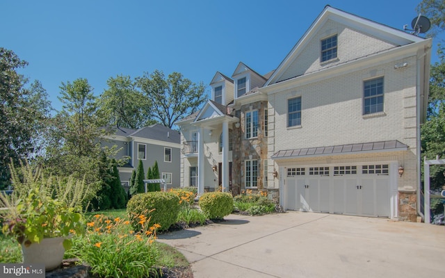 greek revival inspired property with a garage