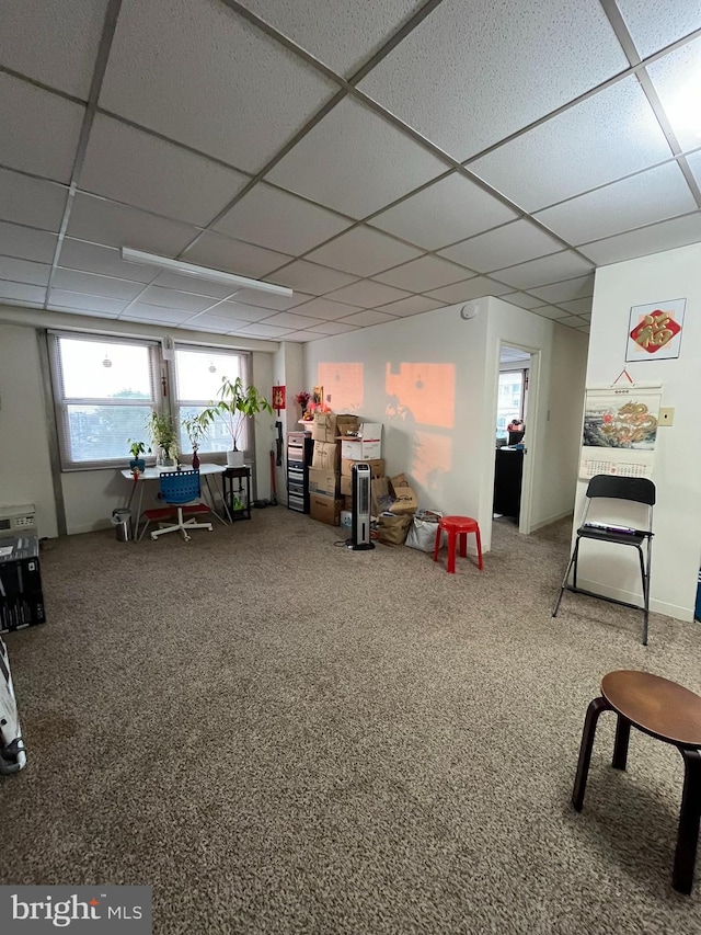 game room with carpet floors and a paneled ceiling